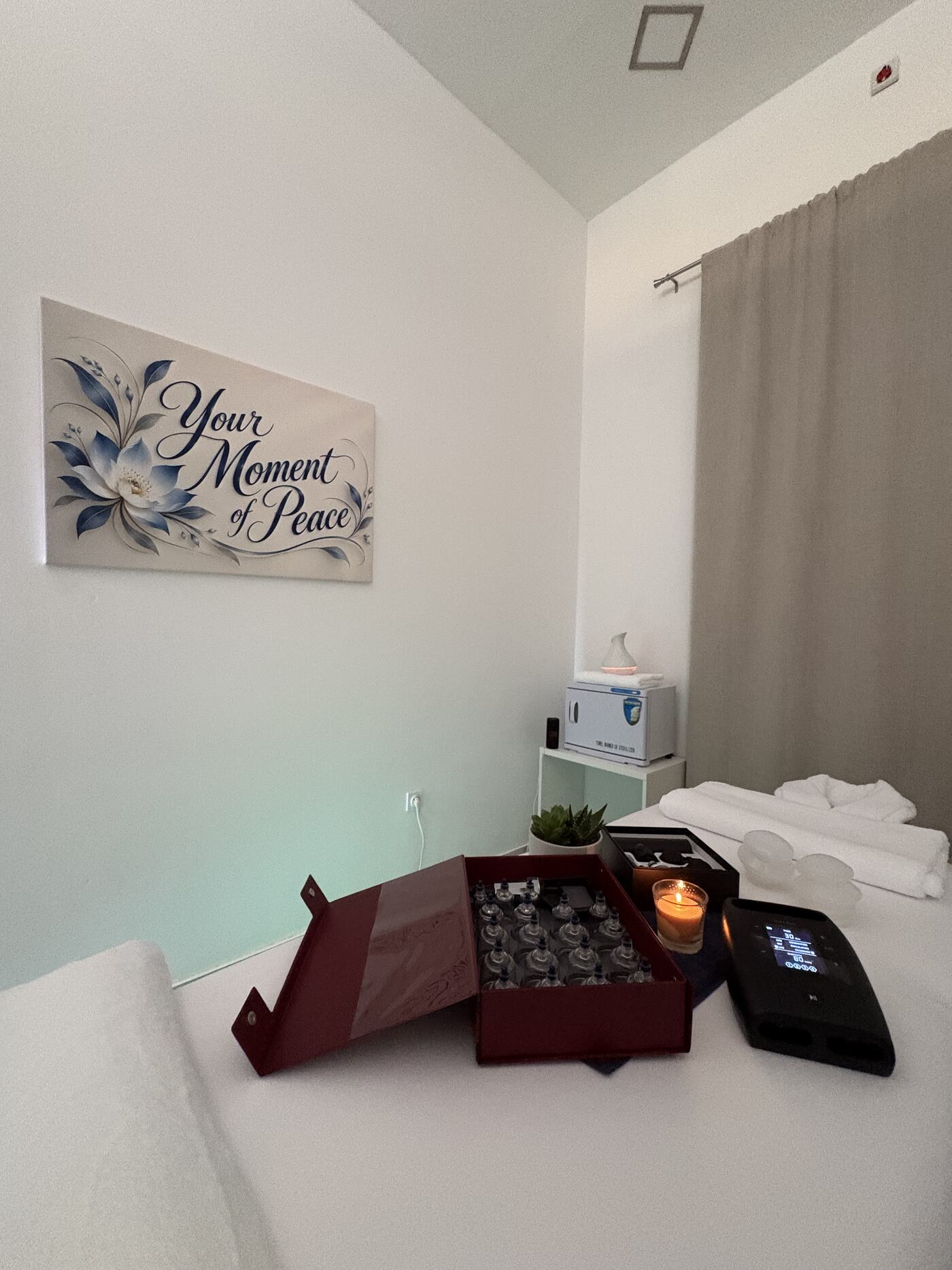 Treatment room with a massage table and cupping set