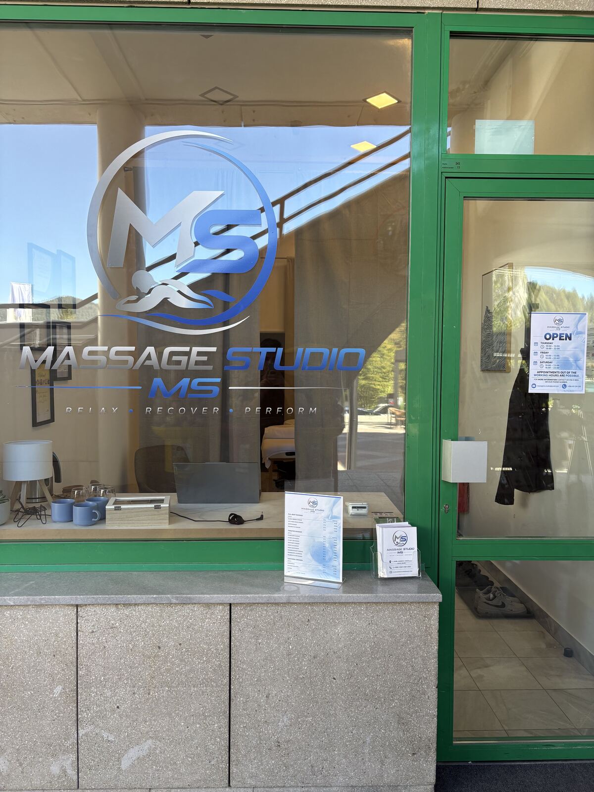 The entrance to MS Massage Studio with the logo on the glass door